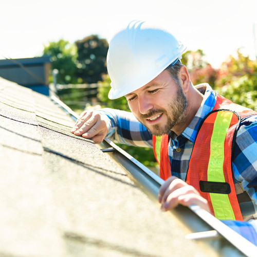 worker inspecting a roof